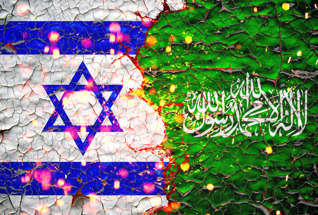 Israel and hamas flags painted over cracked concrete wall. Image credit: iStock