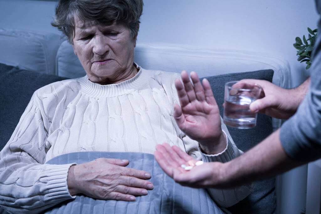 A woman refuses medication. Image credit: iStock