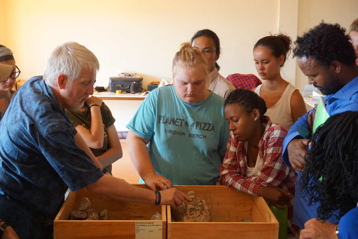 A photo of a scientist talking with students