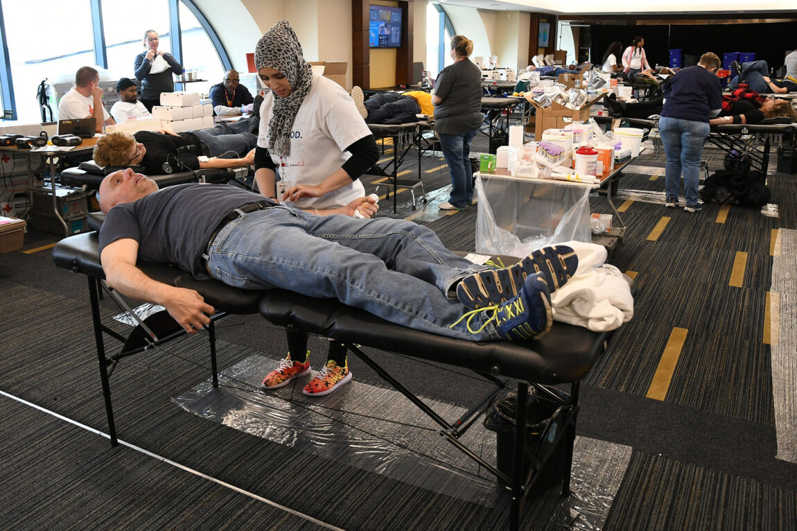 Photo of blood donors and Red Cross technicians at the Big House.
