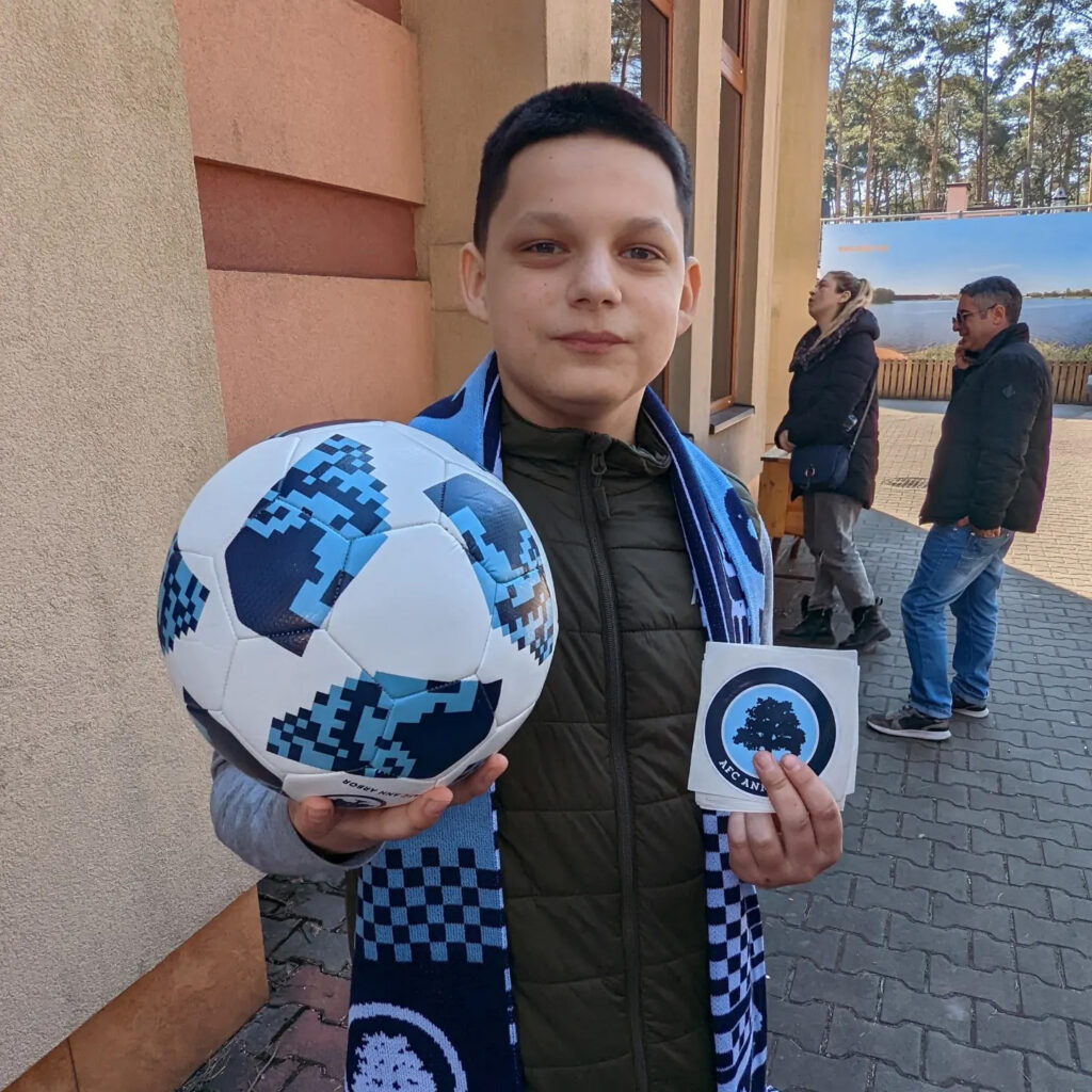 A photo of a boy holding a soccer ball.