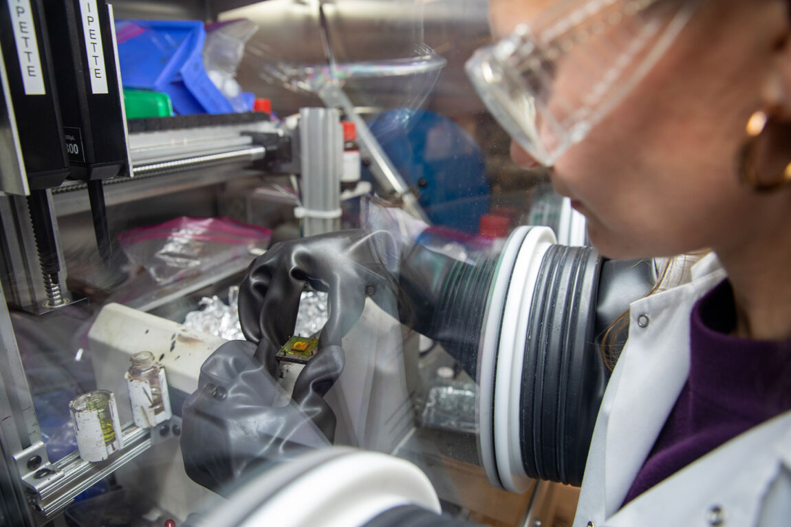 A photo of a Ph.D. student in a lab.