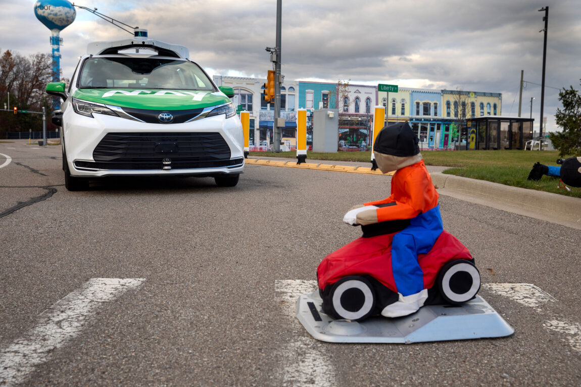 A photo of a driverless car stopping for a simulated passerby