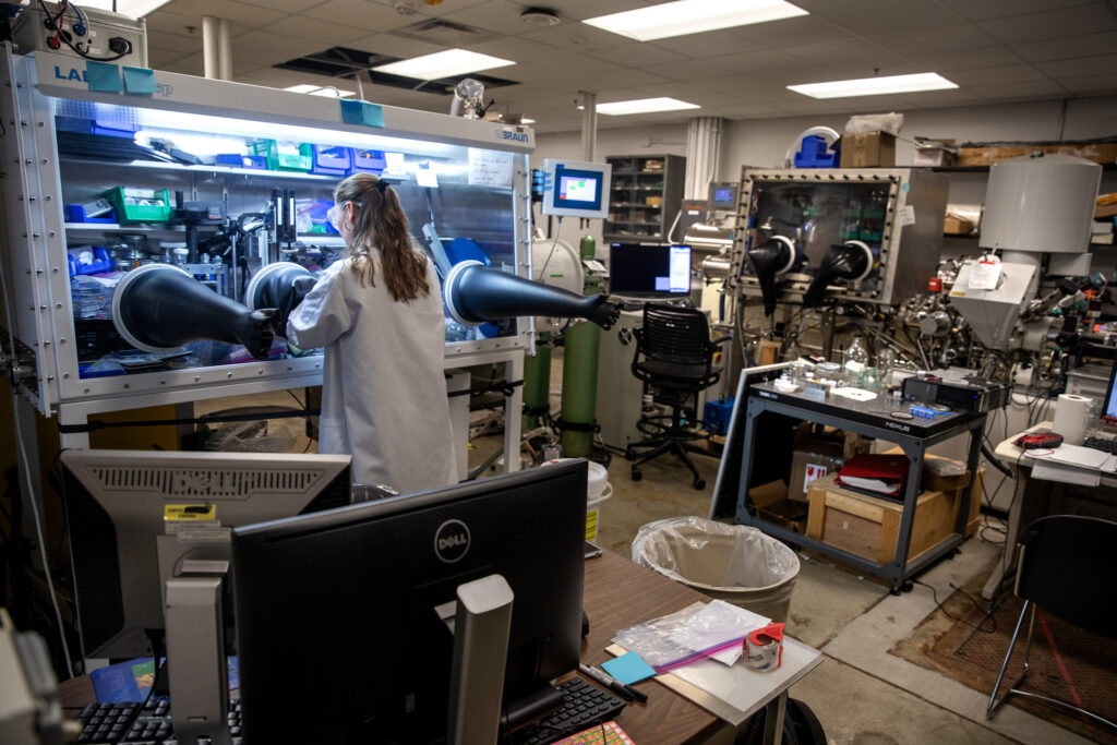 Clare Langhan, a University of Michigan PhD student in mechanical engineering, spincoats thin-film perovskite samples in glovebox—a key step in the creation of perovskite solar cells. Image credit: Marcin Szczepanski/Lead Multimedia Storyteller, Michigan Engineering