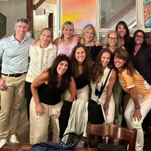 A bunch of happy Michigan alumnae pose with one man.