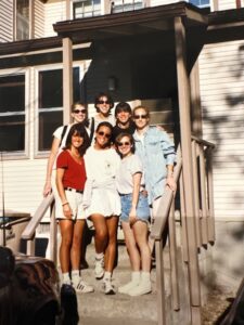 Seven Michigan females pose on the porch of a rickety Ann Arbor house.