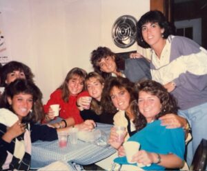 A group of college girls in the late 80s with big hair.