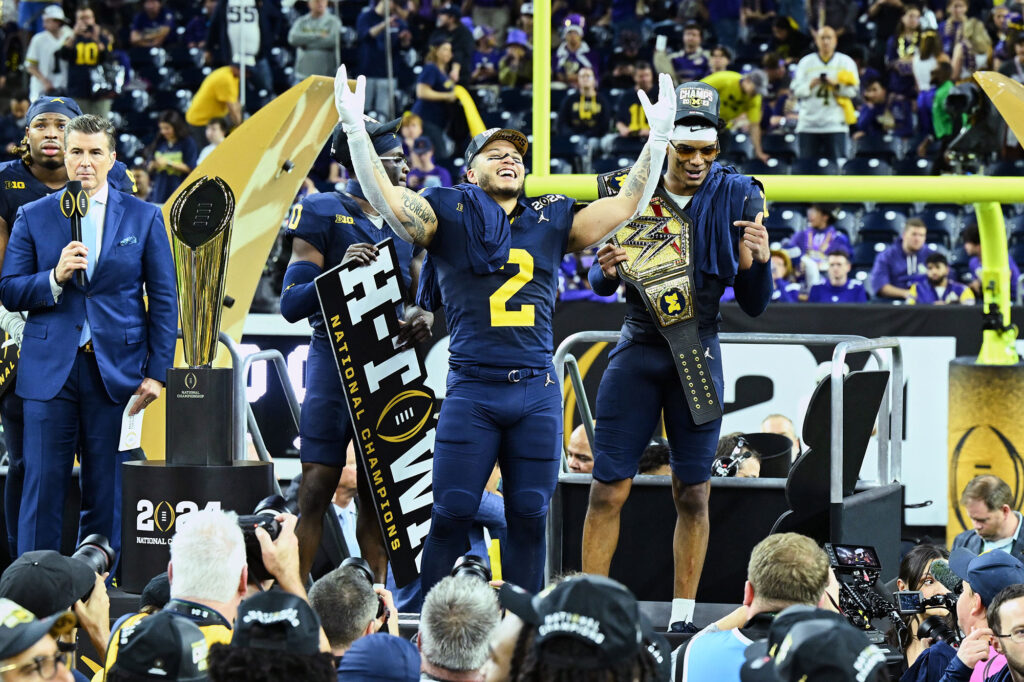 photo of running back Blake Corum acknowledging the crowd during the trophy presentation ceremony.