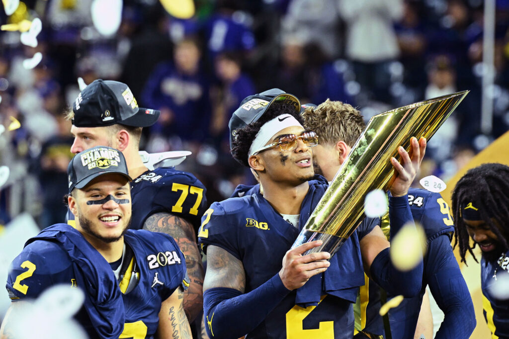Photo of defensive back Will Johnson holding the national championship trophy.