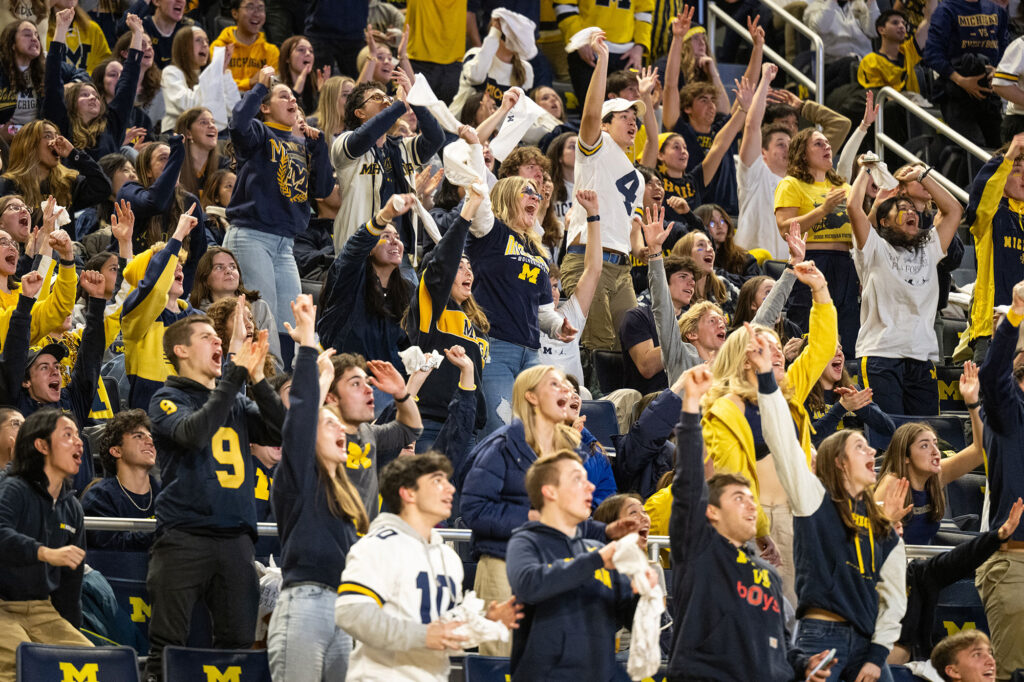 Photo of students cheering during a watch party at Crisler Center.