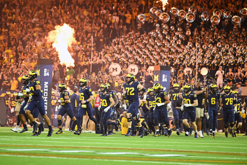 Photo of the the Wolverines taking the field.