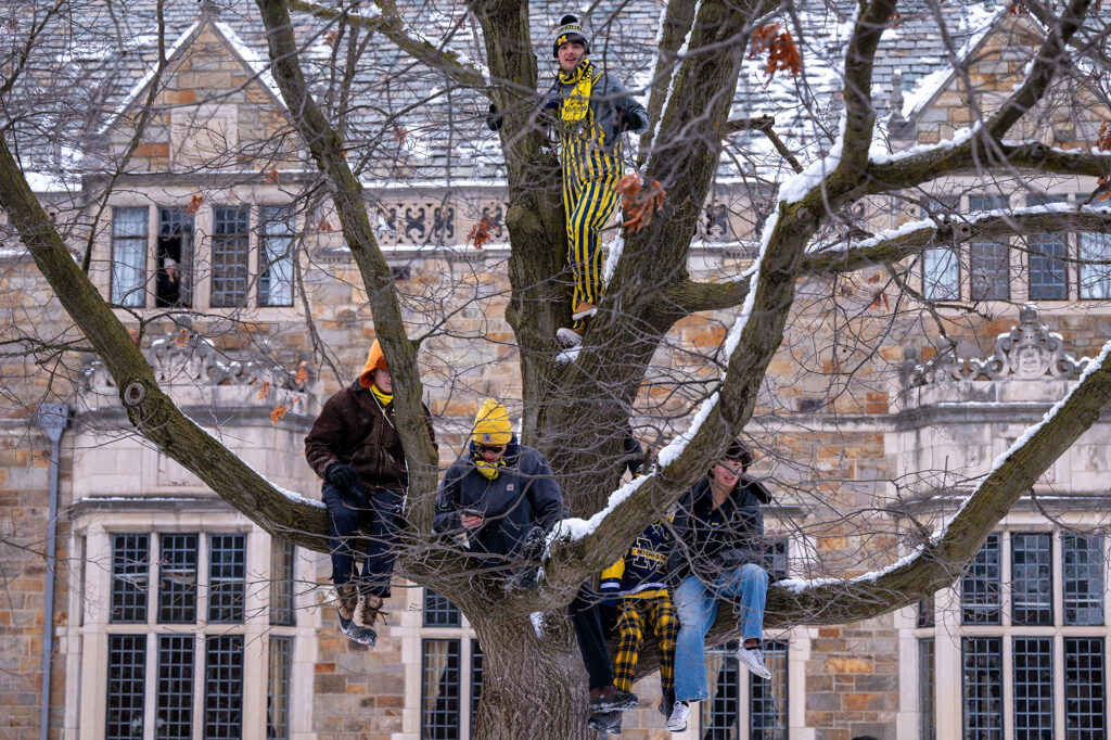 These students found a way to see above the crowd at the parade's starting point on South University Avenue. 