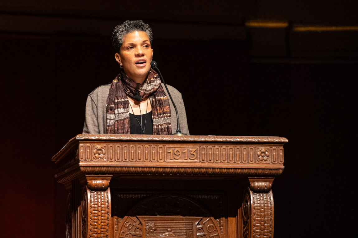 Photo of Michelle Alexander at a podium delivering the MLK Symposium keynote lecture
