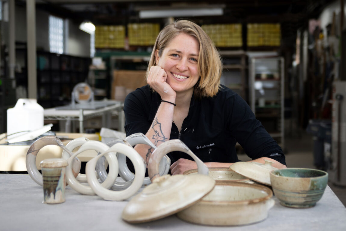 A photo of Katherine Ziska with some of the pottery they are working on.
