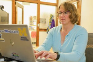 Photo of M-ARC Associate Director Jean Mrachko working at her laptop