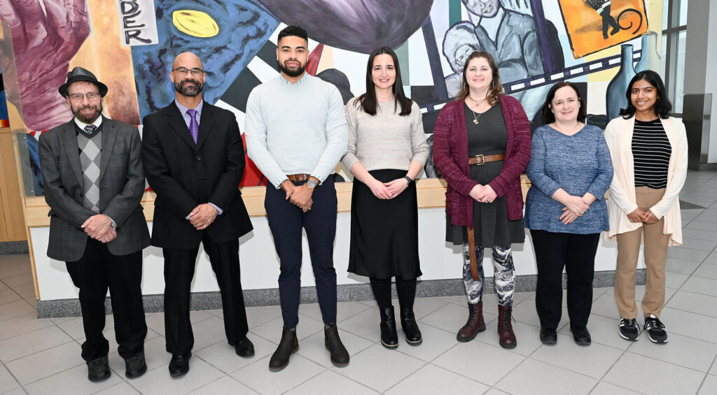 The CRLT DEIJ All-Staff Professional Development Team, pictured L-R: Brian Konz, Jonathan West, Khalid Muneer, Laura Gonzalez, Carol Lagemann, Jeanne Andreoli, and Malini Dasgupta received the U-M Distinguished Diversity Leaders Team Award in a ceremony held at Palmer Commons in Ann Arbor, Mich., Tuesday, Jan. 30, 2024. Not shown: Mishelle Dimitrova, Linda LaNoue, Elizabeth Mann Levesque, Megan Stowe, Esther Witte