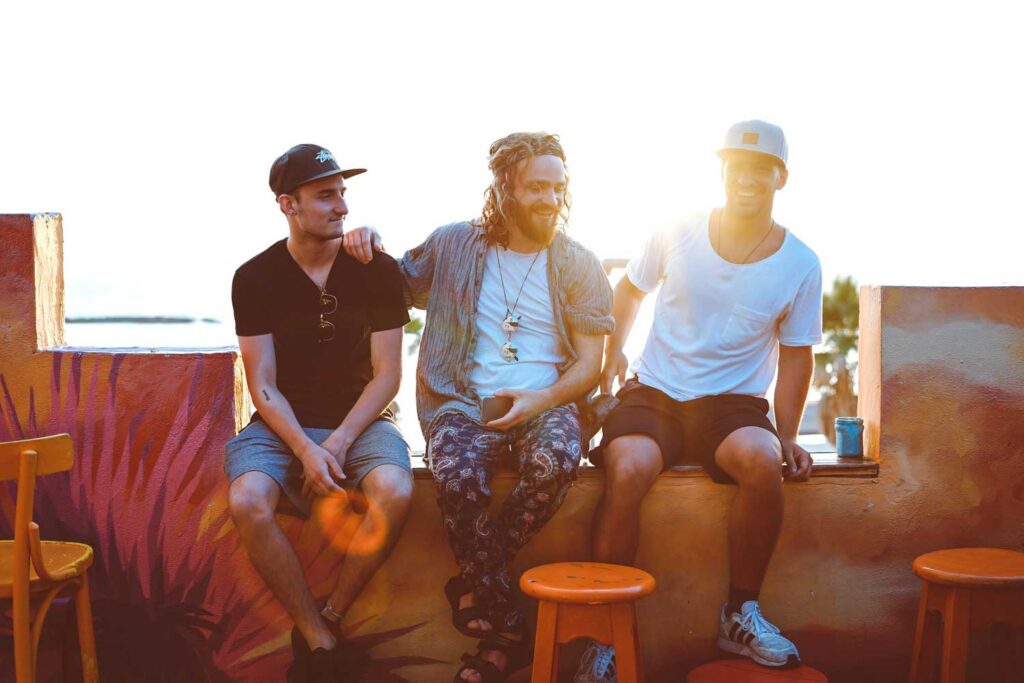 Three male friends socializing. Image credit: Toa Heftiba, Unsplash/CC0 Public Domain