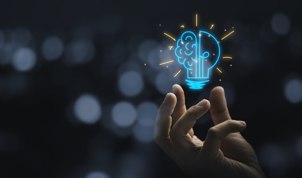 Concept illustration of knowledge with a hand holding a virtual light bulb with brain. Image credit: iStock