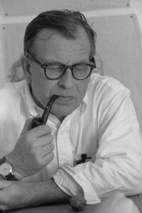 Photo of Eero Saarinen, the designer of North Campus, smoking a pipe