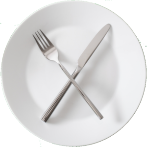 An empty white plate with a criss-crossed knife an fork serves as a visual metaphor for fasting.