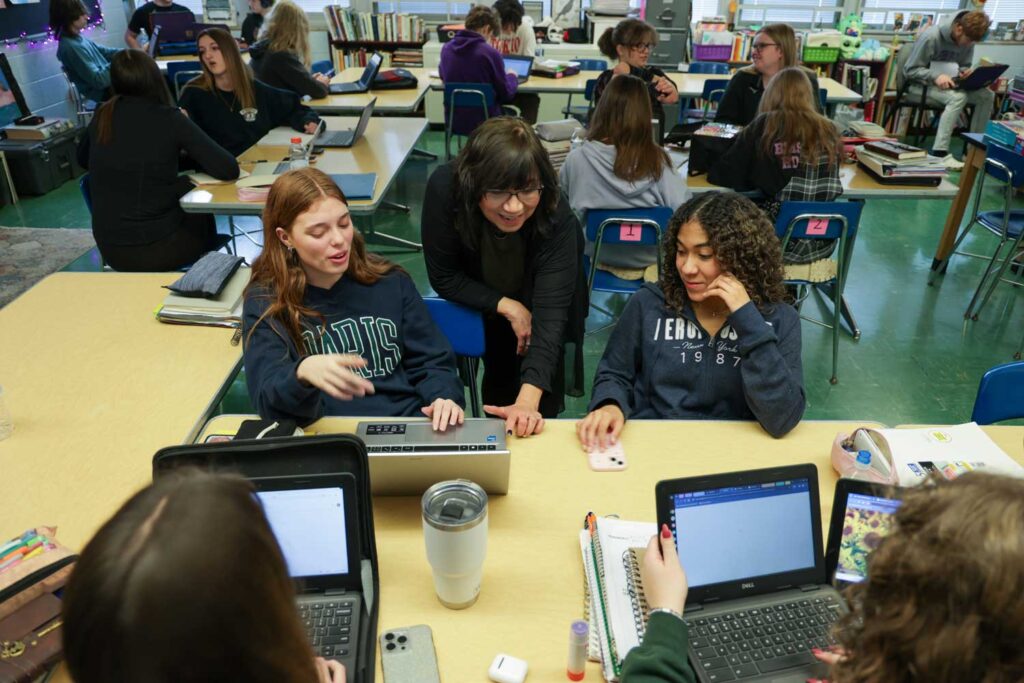 Ylisse Yepez works with students during her English class at Blissfield High School.