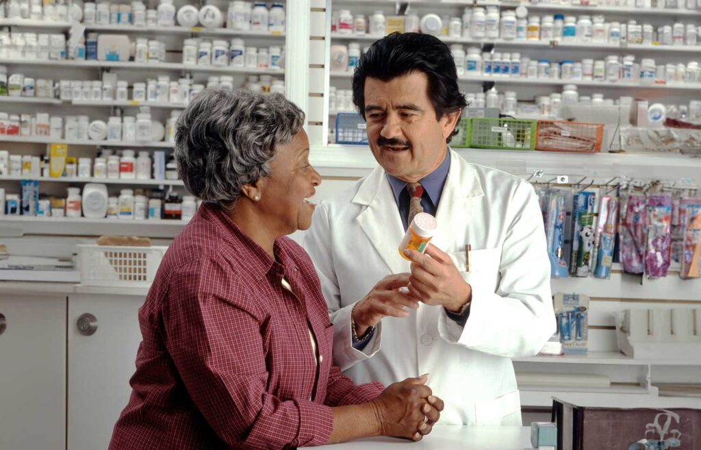 A pharmacist in conversation with a patient. Image credit: ational Cancer Institute, Unsplash.com