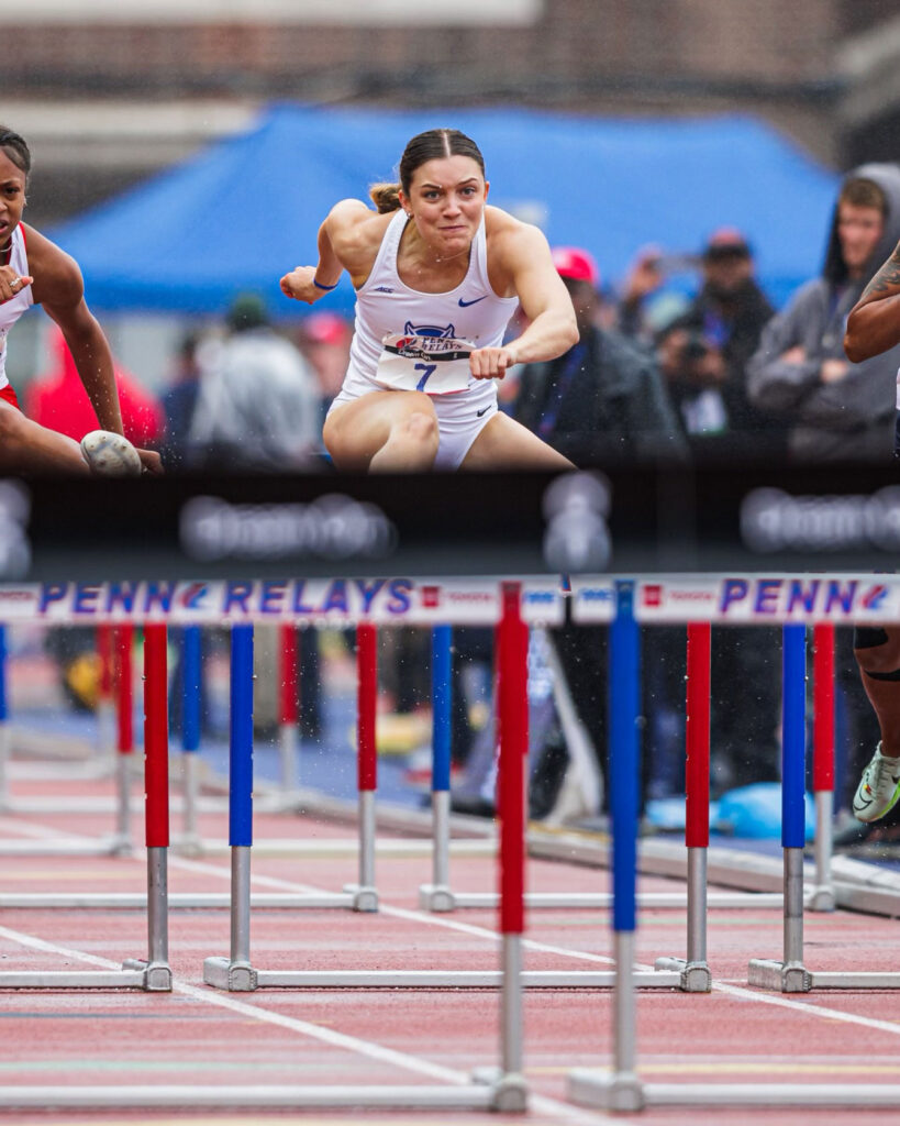 A photo of a woman competing in the hurdles