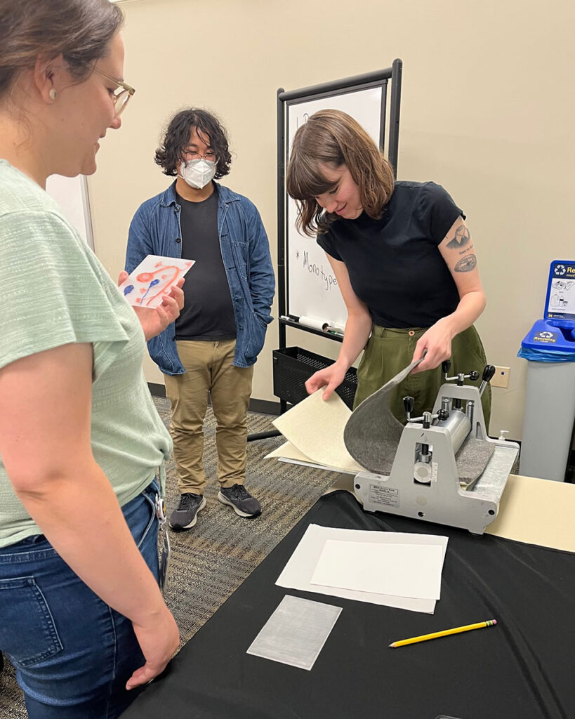 Photo of neuroscience grad students creating monoprints at a workshop last summer