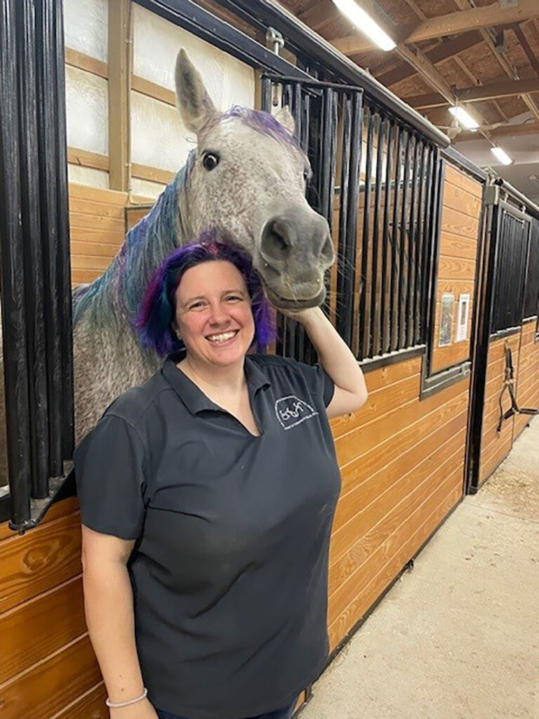 A photo of a woman with a horse