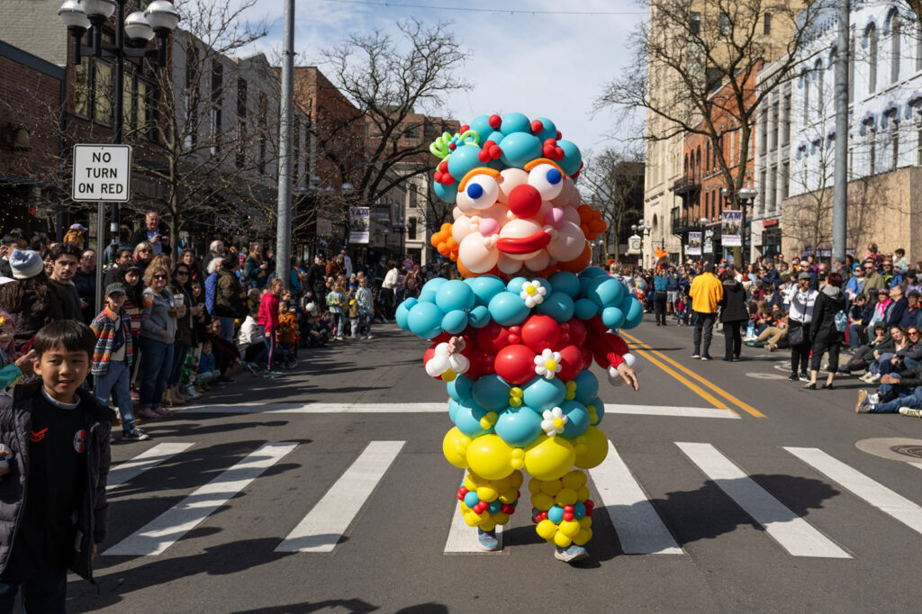 Photo of a giant walking figure made of colorful balloons