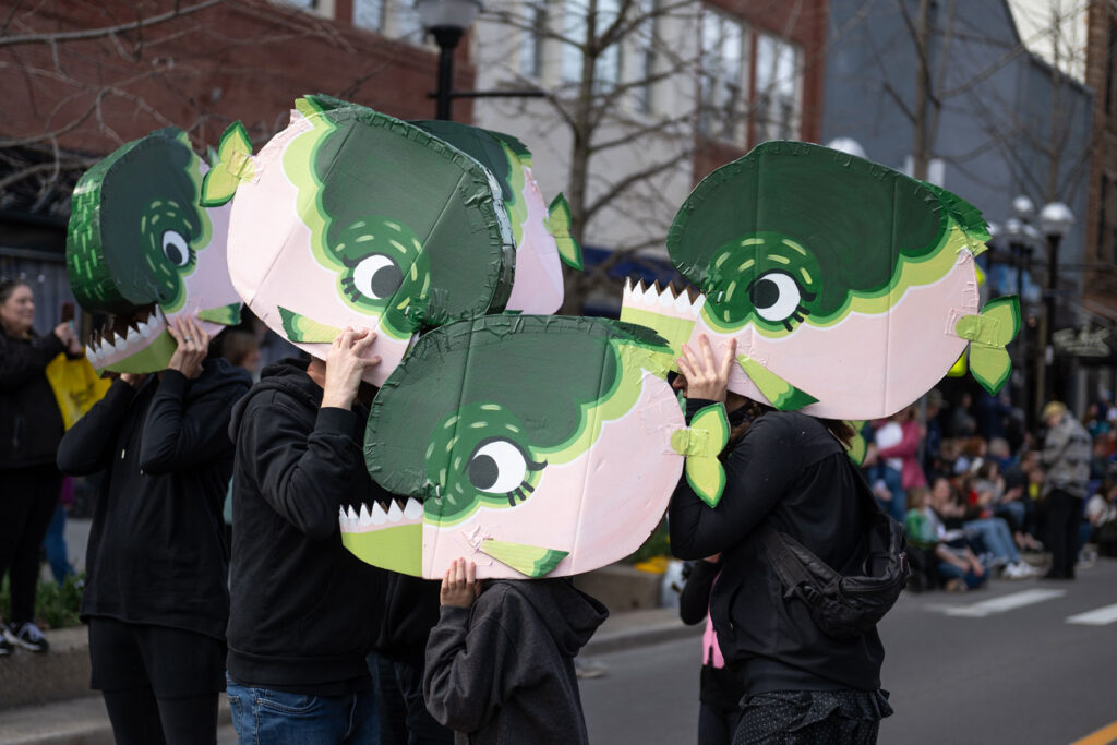 Photo of people wearing cardboard fishheads