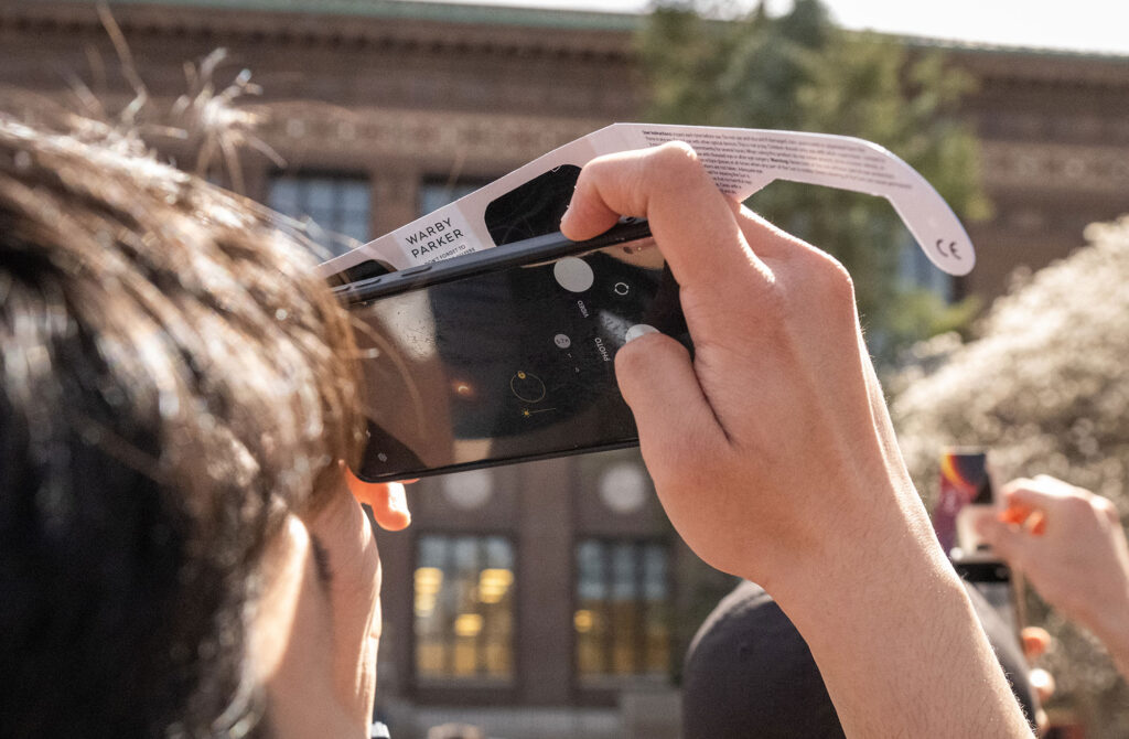 Photo of a person taking a photo through protective glasses