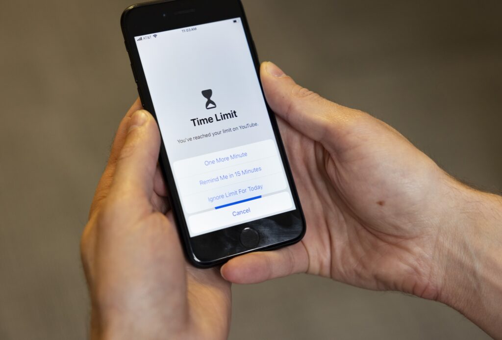 A smartphone displays that the phone's owner has reached their screen-time limit on YouTube. A notification at the bottom of the screen asks if the user would like 1 or 15 more minutes of YouTube, or if they would like to cancel their YouTube limit for today.