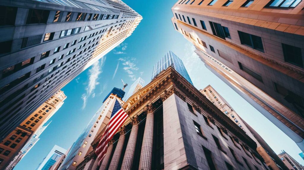 Concept photo of a stock market building with the American flag flying on it, looking up at buildings in New York City, with blue sky and clear weather. Image credit: Nicole Smith, made with Midjourney
