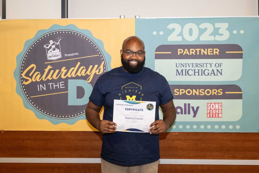 Rapheal French poses with his certificate of completion. Image courtesy: Saturdays in the D