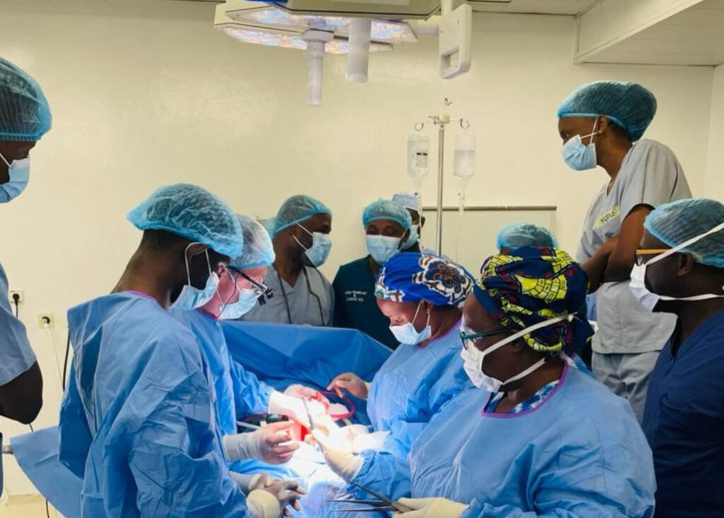 A photo of multiple surgeons performing a kidney transplant