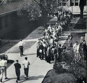 Registration days weren’t always sunny, like this one in 1951. Students are snaked around a building in a huge long line to register for classes at Waterman Gym at U-M. (Image courtesy of Bentley Historical Library)