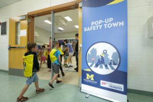 Children enter Pop-Up Safety Town, a U-M initiative that's helped thousands of pre-school and grade-school students in Michigan avoid concussions and other injuries. Image credit: Jeremy Marble
