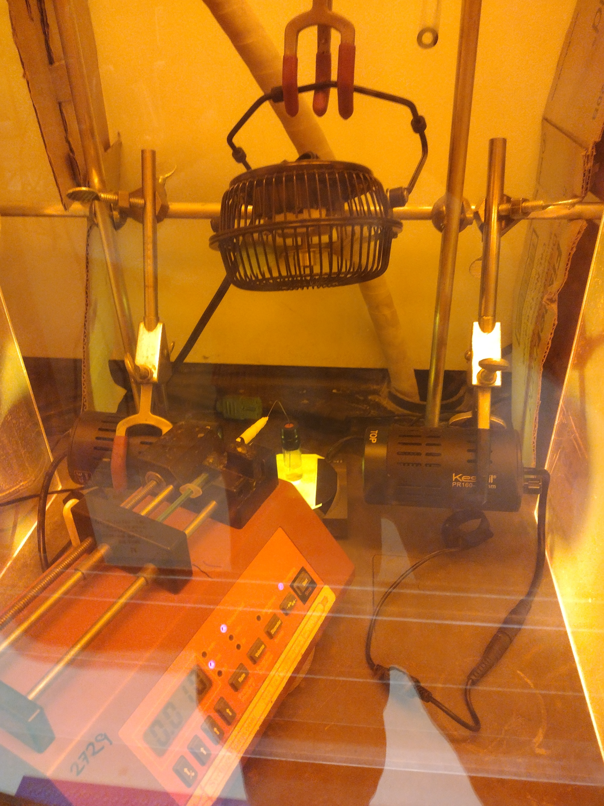 Reaction being demonstrated on an increased ~0.5 g scale using a syringe pump. The orange box protects the chemist from high energy blue light from the lamps. Image credit: Emily Wearing