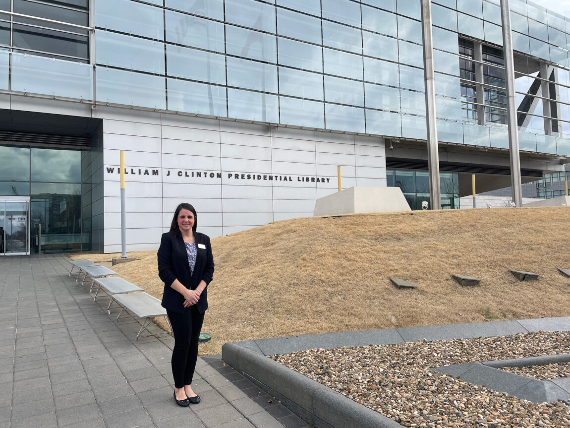 A photo of a woman standing outside a library