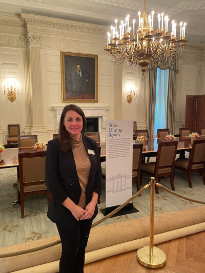 A photo of a woman standing inside the White House