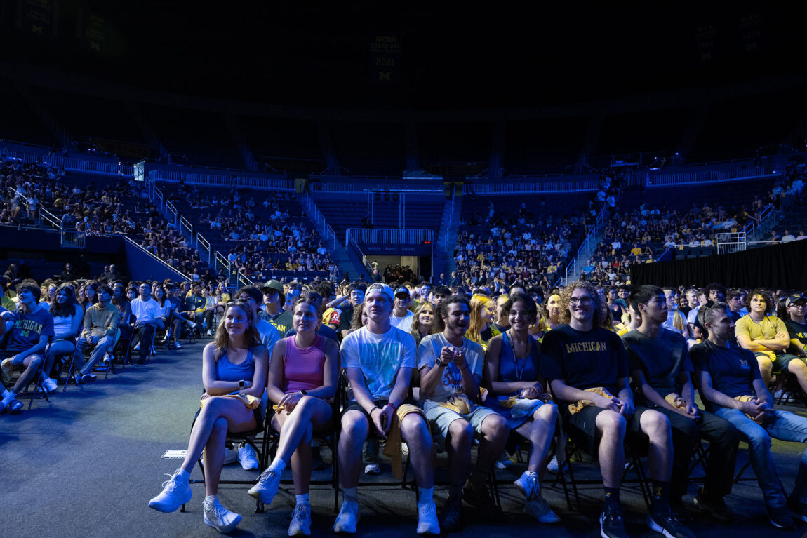Students seated on floor of Crisler Center.