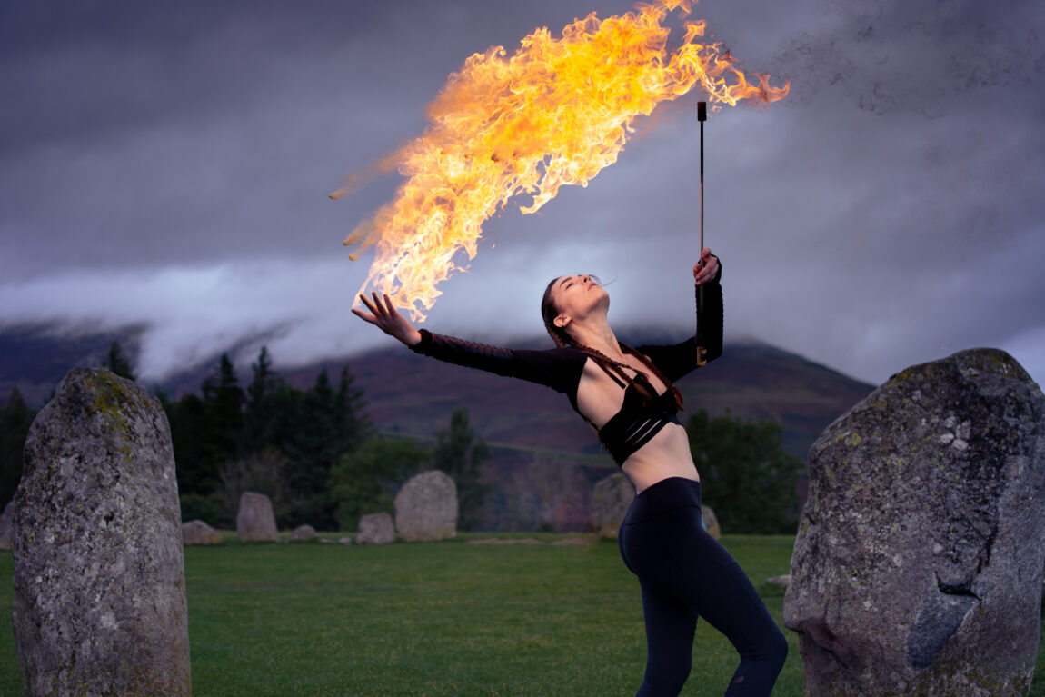 A photo of a woman taking part in fire spinning