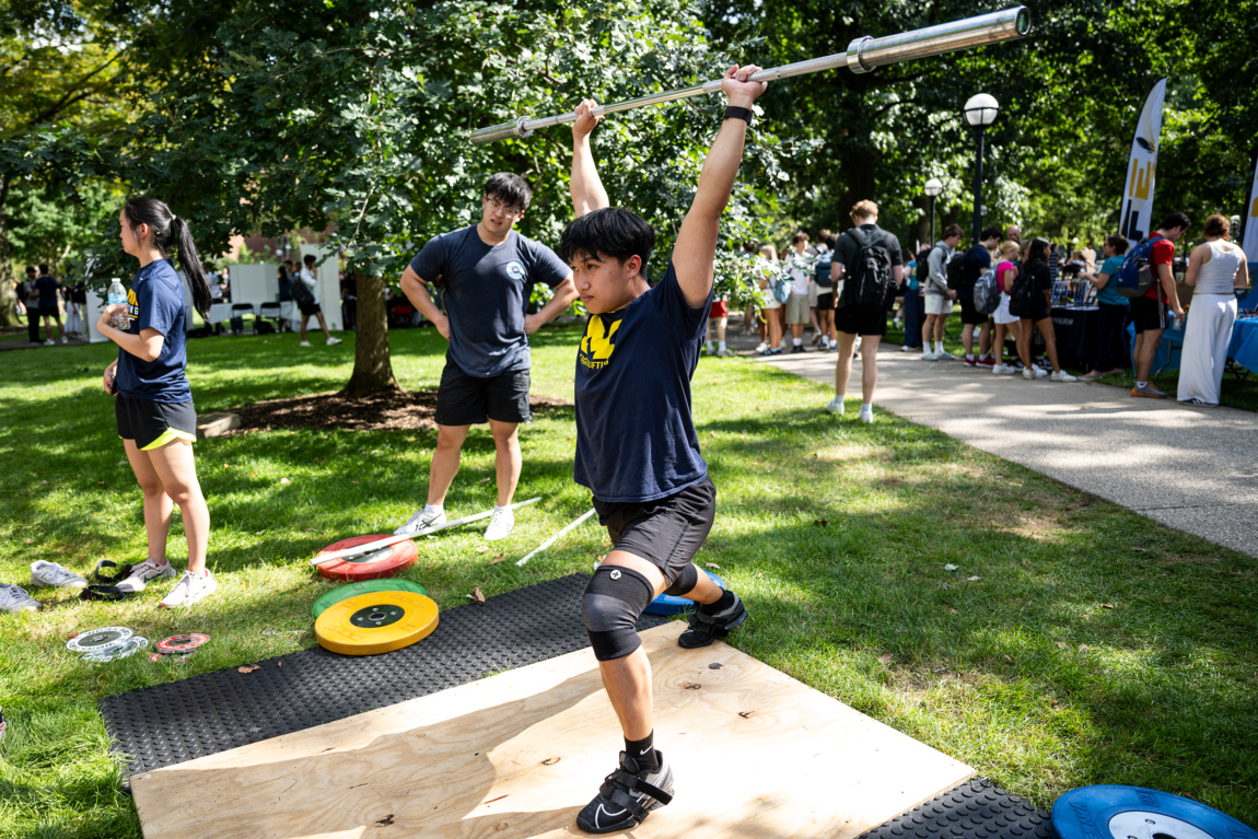 A photo of a person lifting a bar