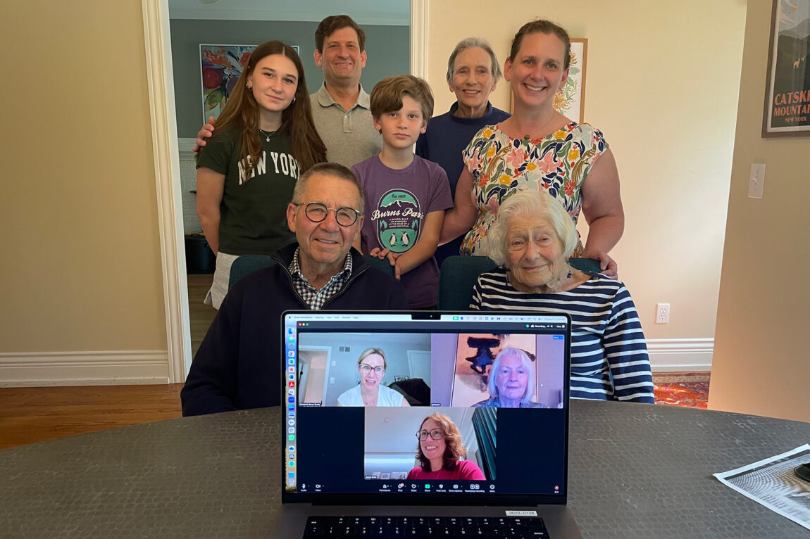 Photo of several family members with a laptop and images of more people