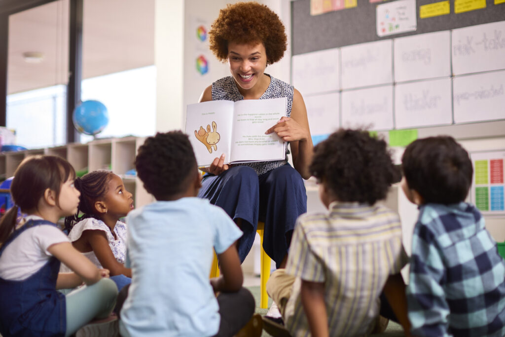Elementary school teacher reading to students. Image credit: iStock