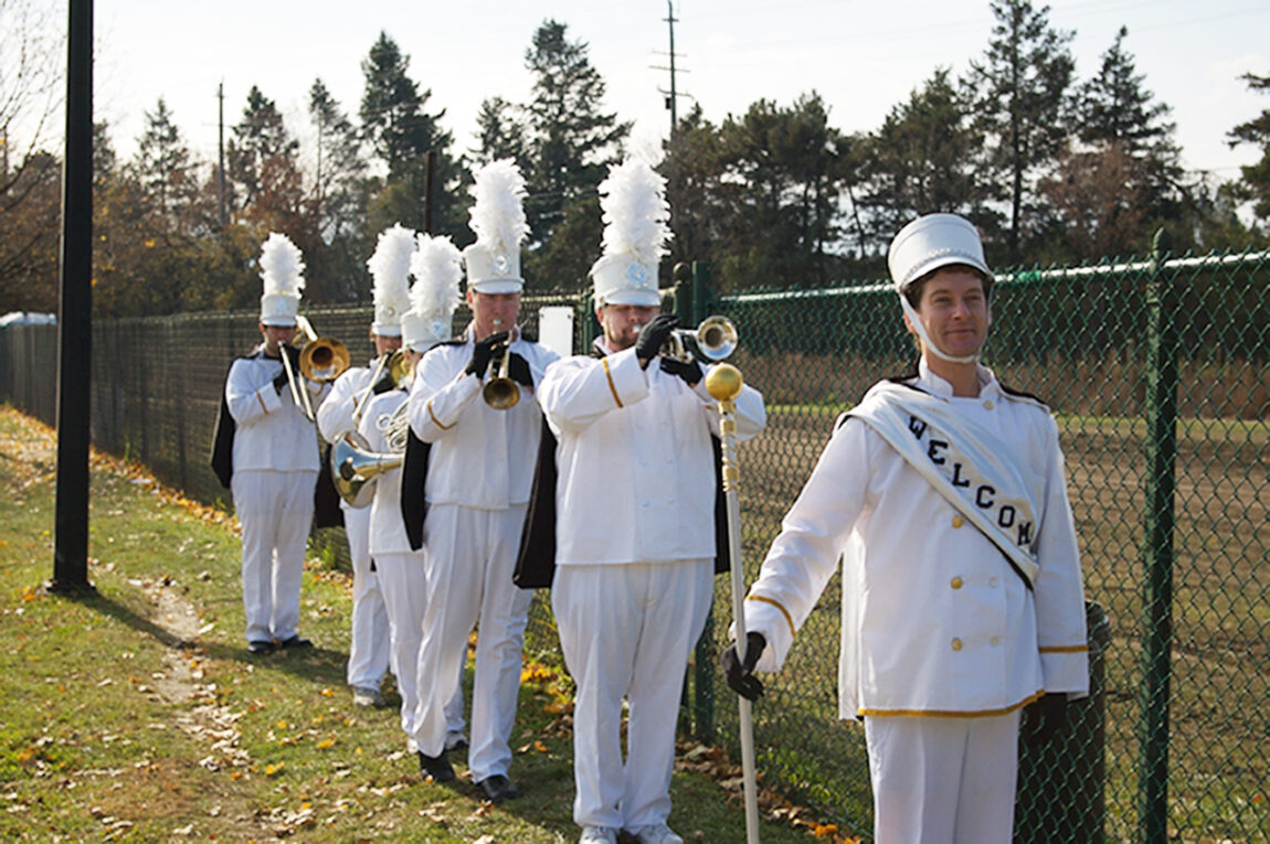 A photo of people marching in a band