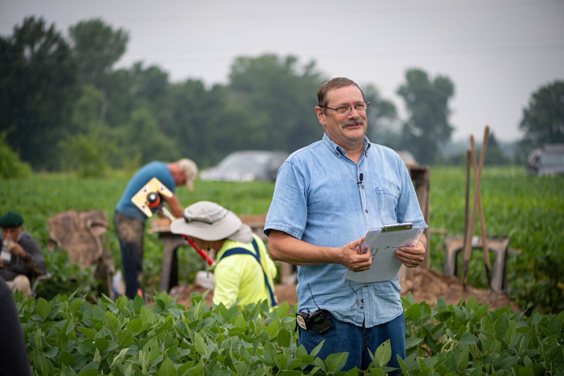 A photo of a man outside in a field.