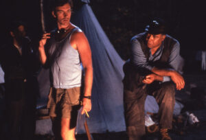 John sayles and James Earl Jones on the set of 1987's Matewan. Director Sayles is wearing headphones and dressed in shorts. Jones is in costume as a miner.