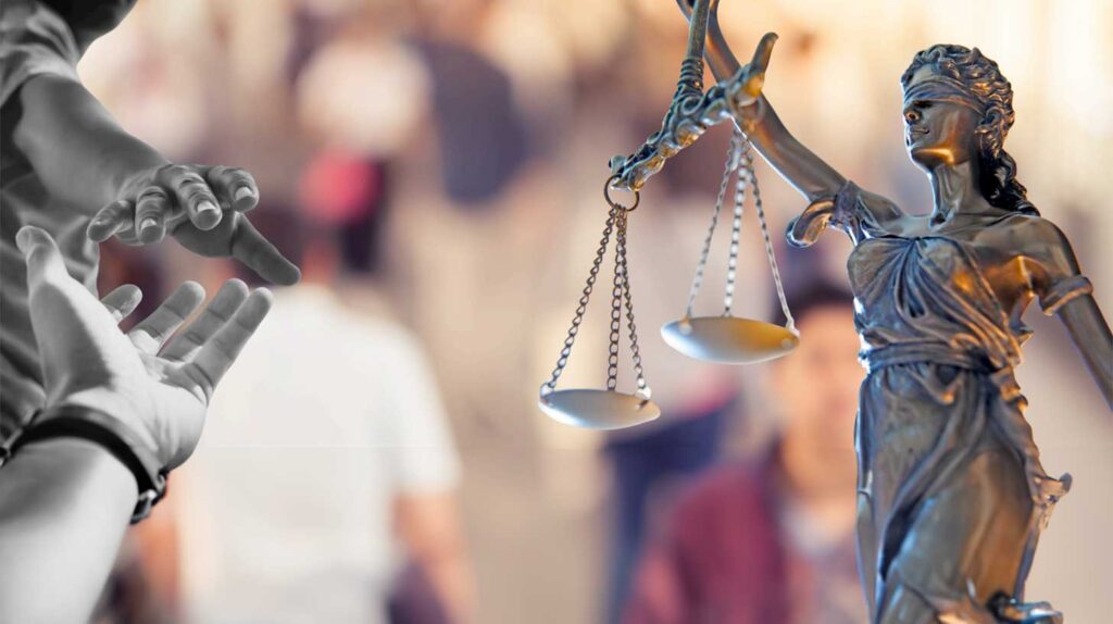 Photo of the Lady Justice statue holding scales. In the blurred background, a scene with a lawyer speaking to a judge while making a "size" gesture with their hands. Image courtesy of the study